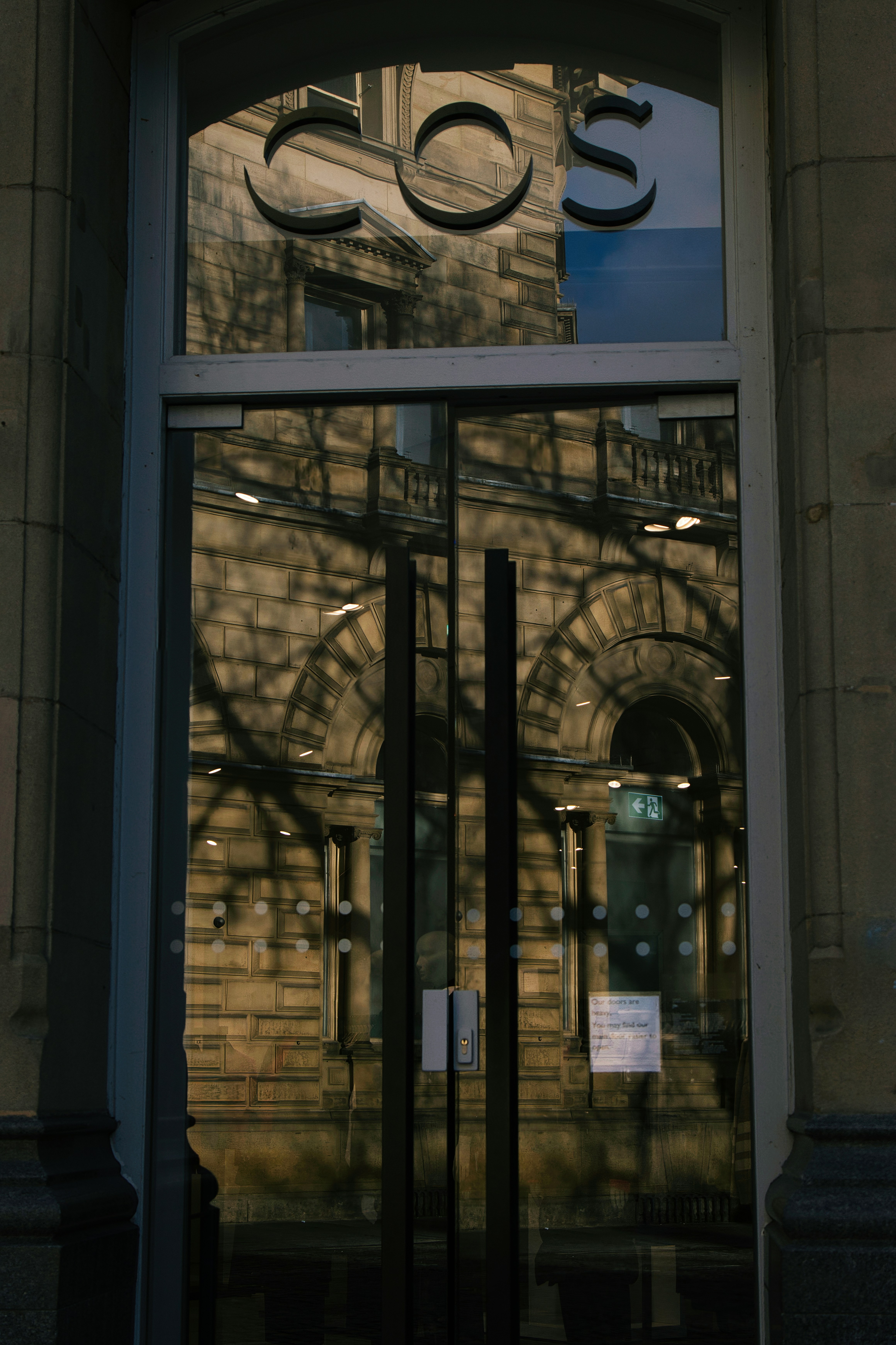 The entrance to a building with a large glass door